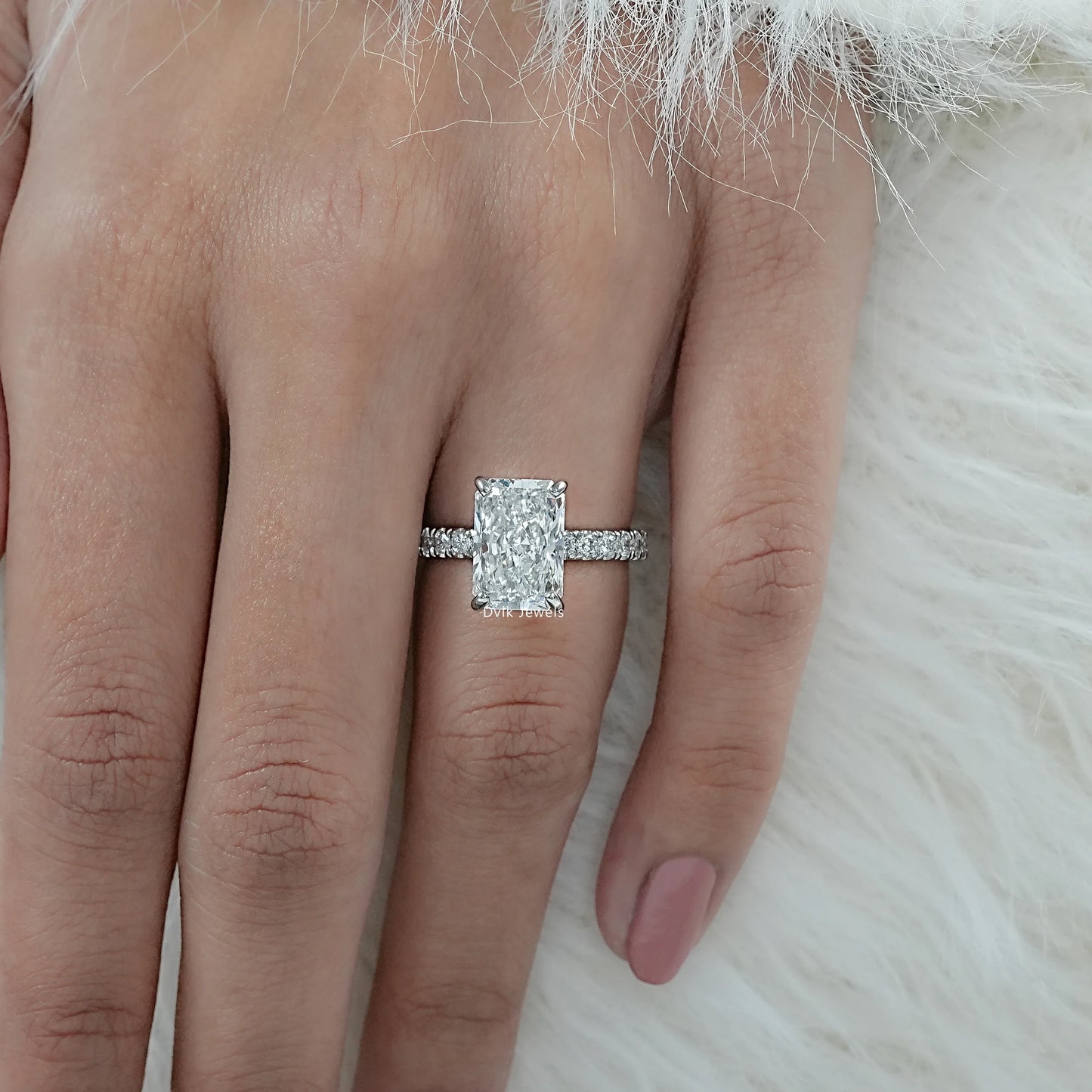 Radiant Cut Lab Diamond Engagement Ring with Round Cut pave stones styled on hand
