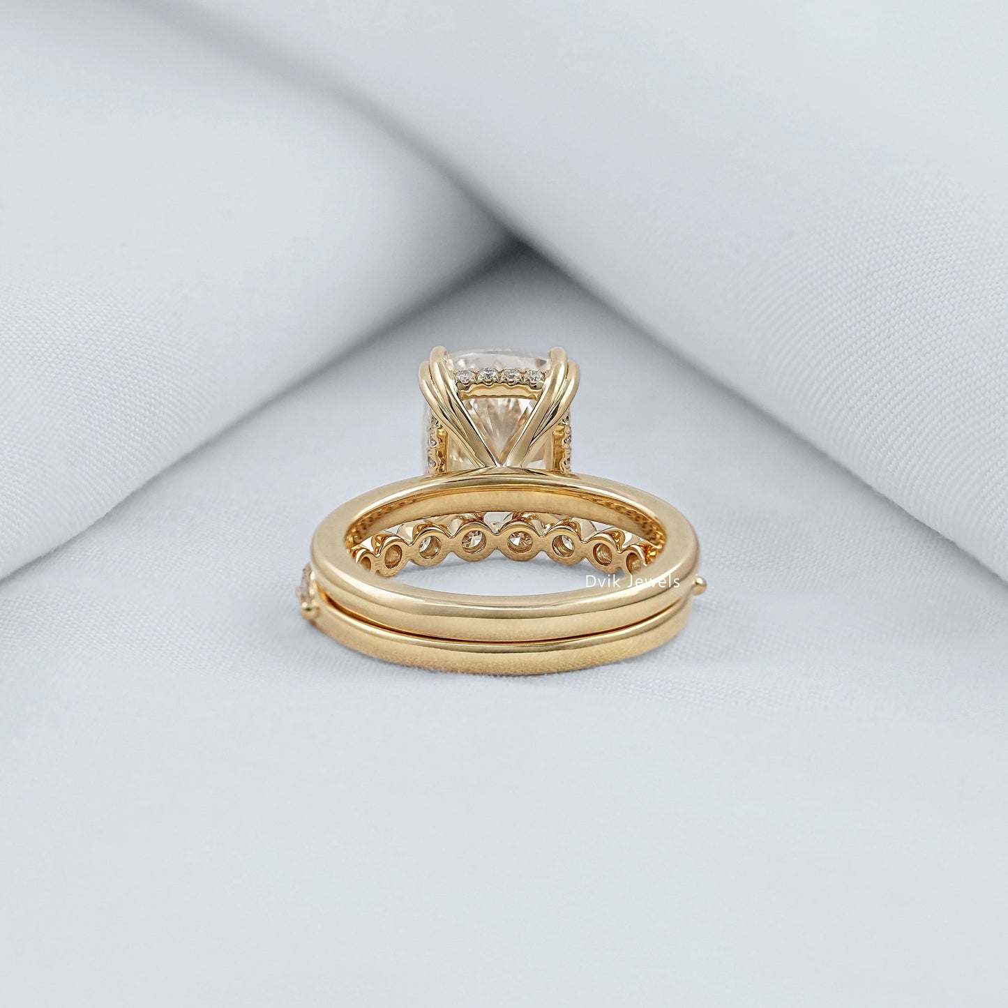 pavé band ring stacked with a solid gold band showing the detailed underside.