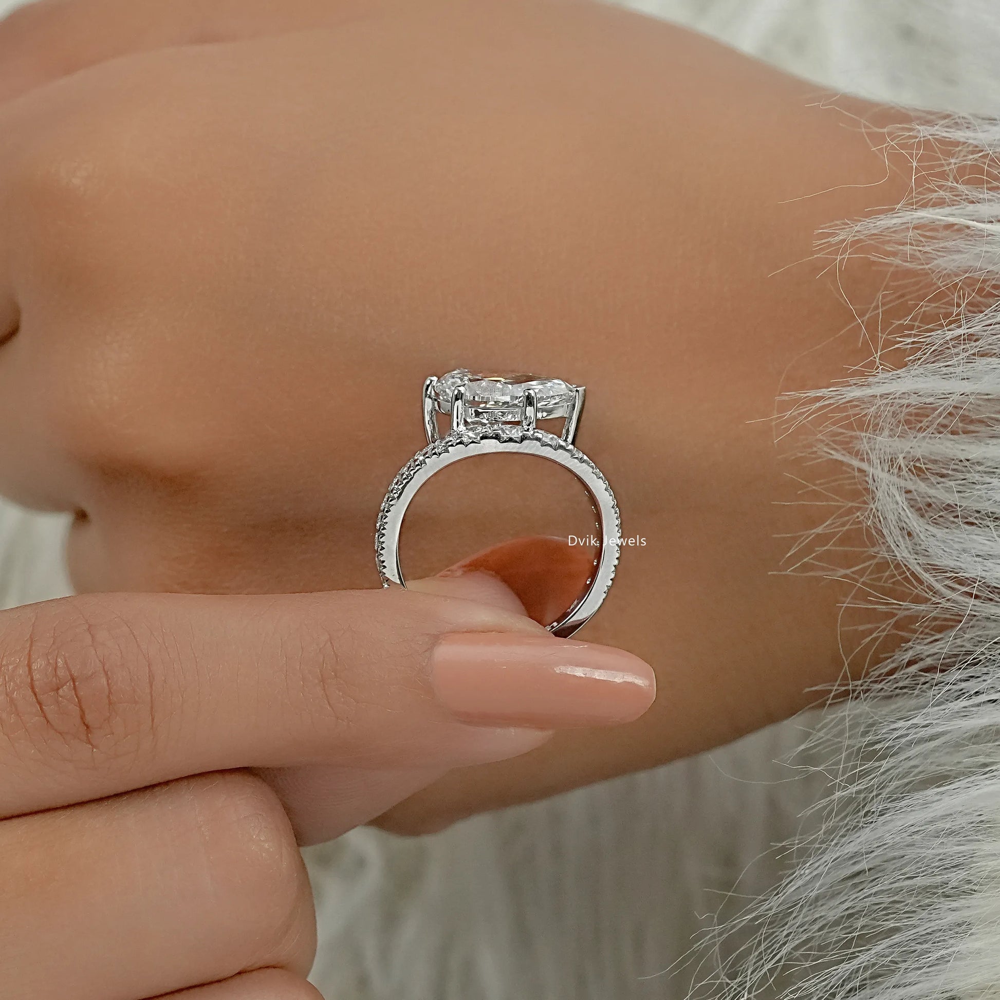 Pear diamond ring profile view showing the elevated bypass setting and pavé.