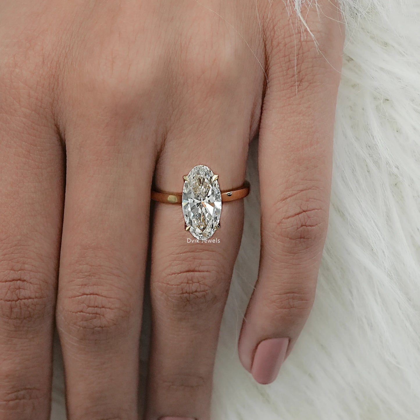 Hidden halo engagement ring worn by women for modern look
