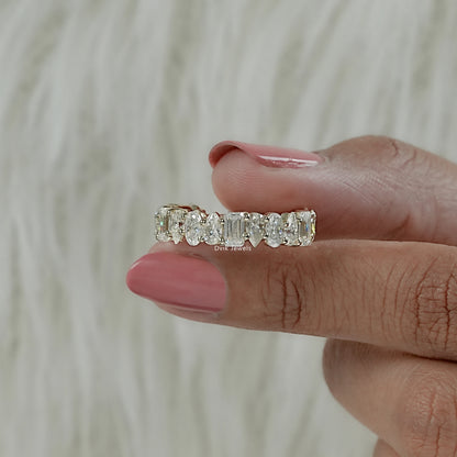 Front view of half eternity lab diamond band with mixed stone hold by women