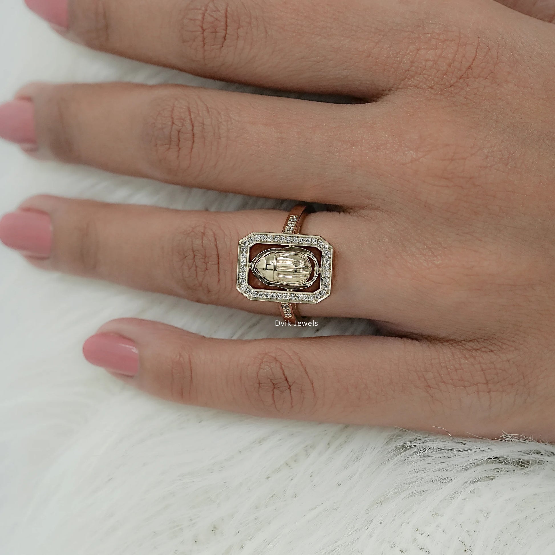 Model wearing a round cut diamond ring with unique geometric diamond halo setting