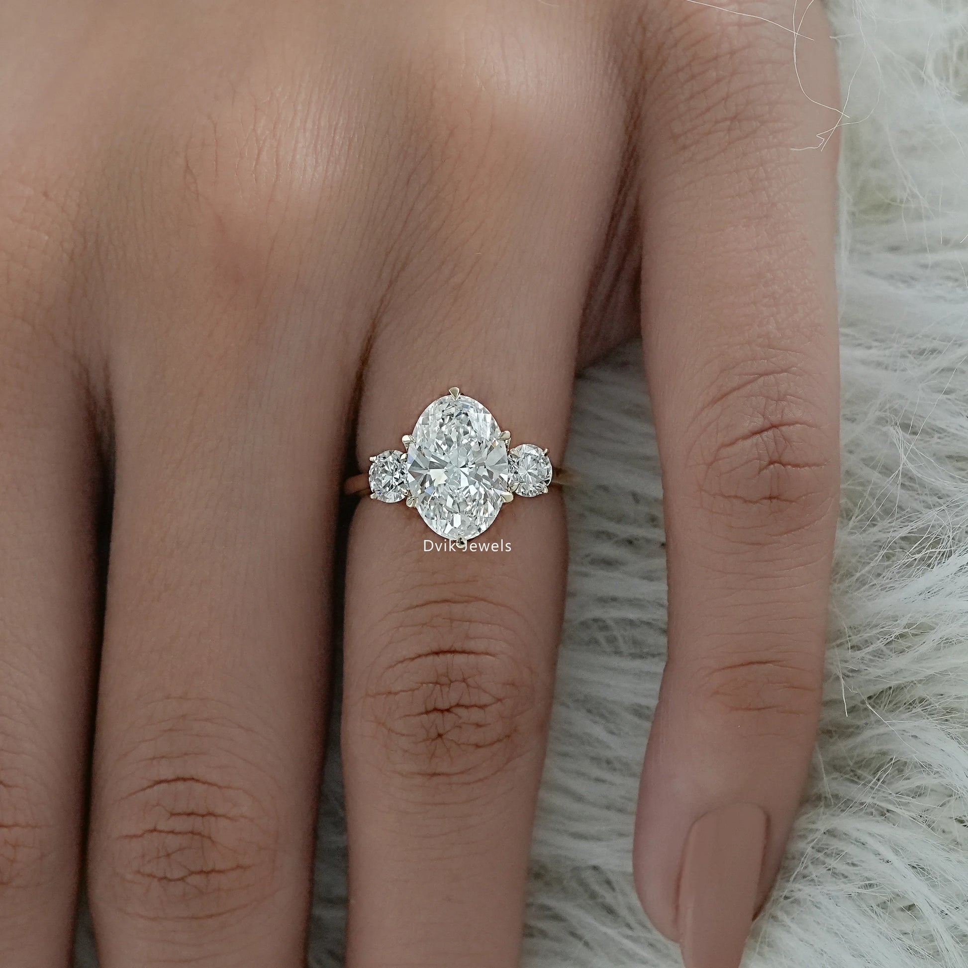 Oval engagement ring with small side stones shown in a detailed close-up