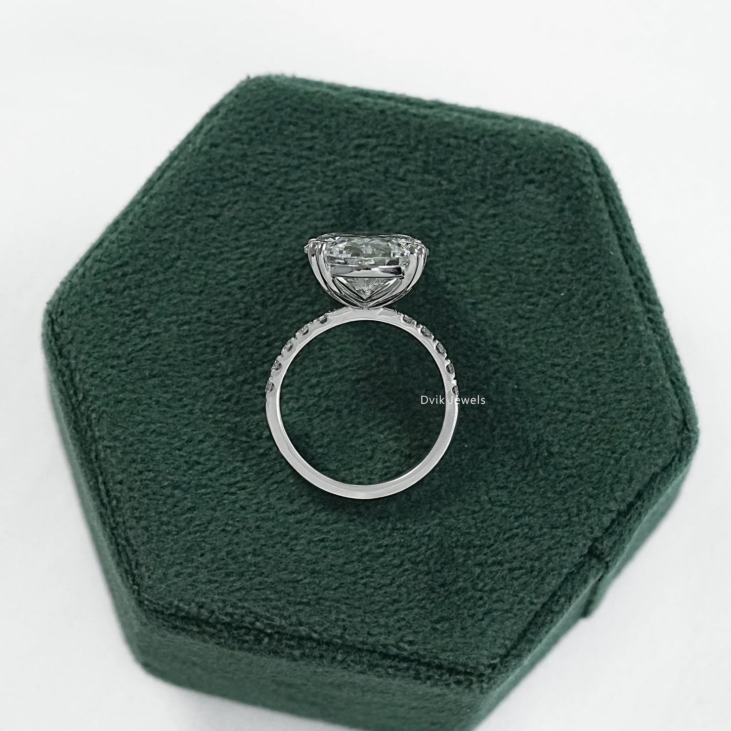 Oval engagement ring with hidden halo displayed on a clean white surface