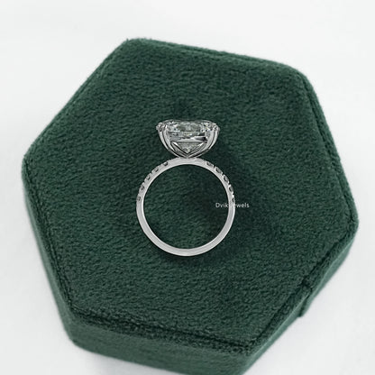 Oval engagement ring with hidden halo displayed on a clean white surface