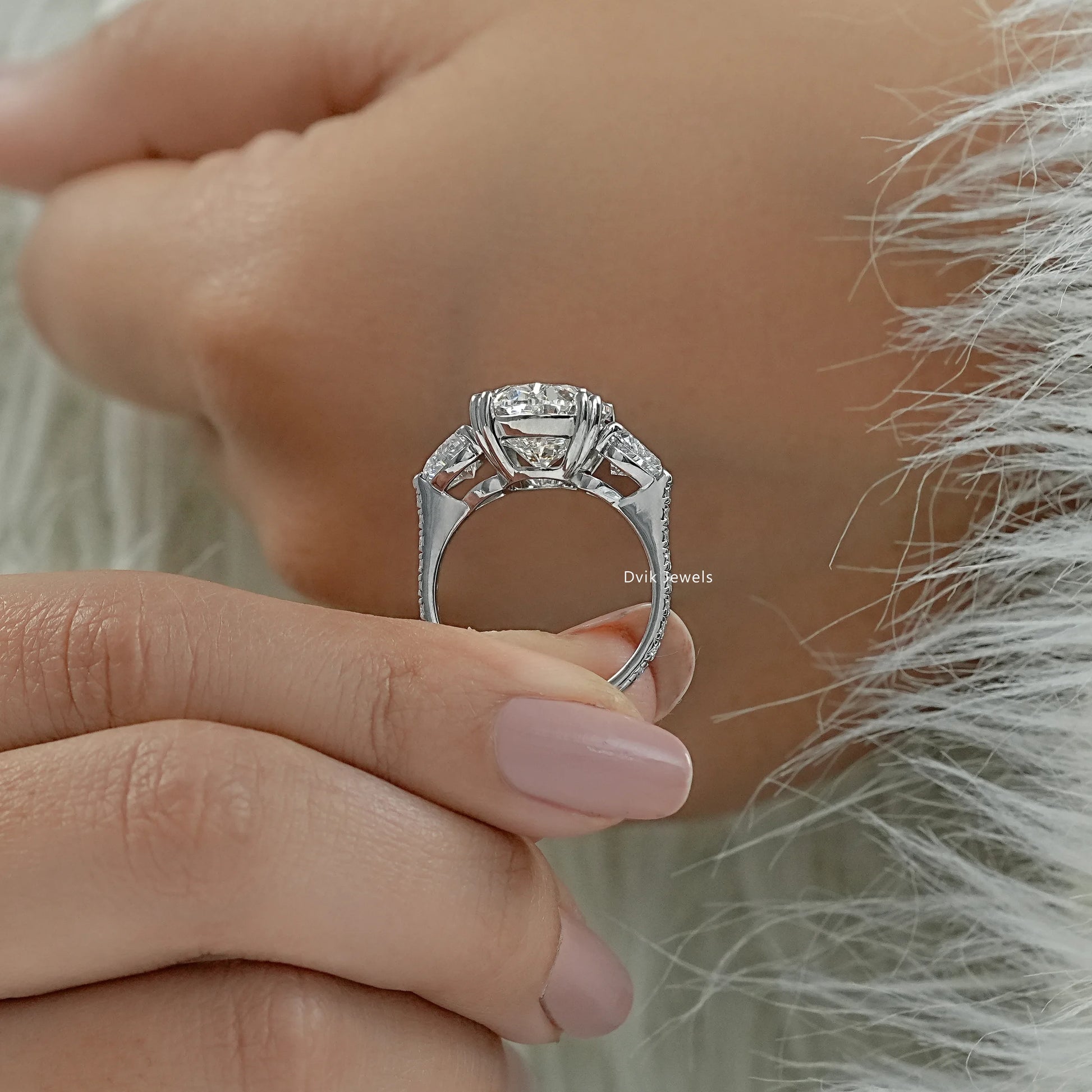 Three stone oval diamond engagement ring heart side stones profile view