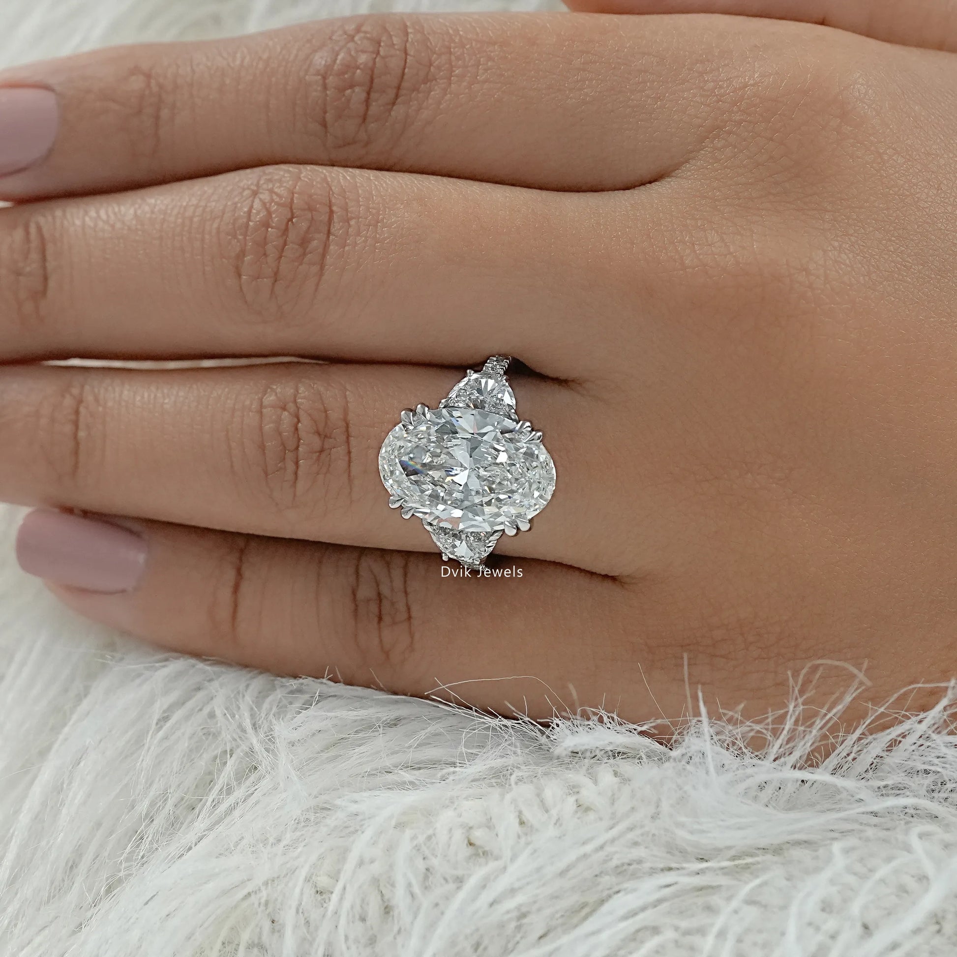 Oval with half moon side stones ring on finger top view