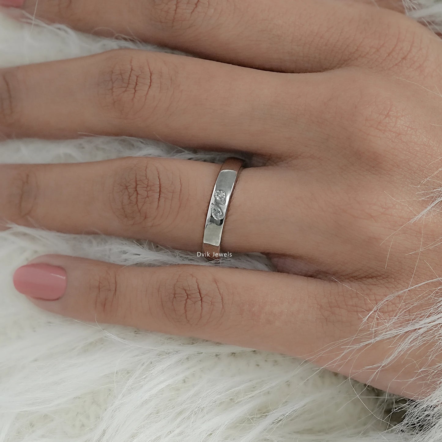 Minimal pear cut diamond wedding band with plain band on model hand