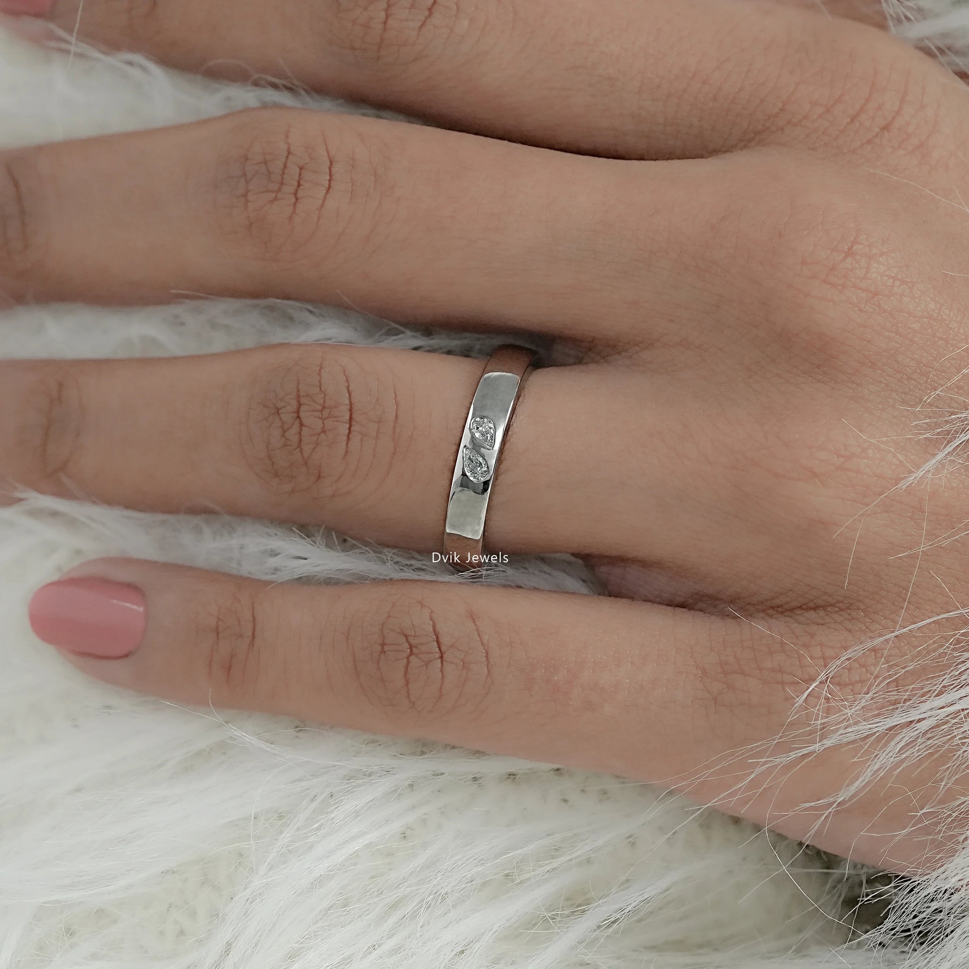 Minimal pear cut diamond wedding band with plain band on model hand