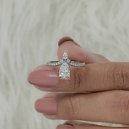 Women hold two pear diamond ring to showing interior band and secure prong setting