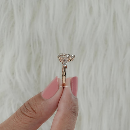 Side view of 5 stone baguette and pear cut engagement ring showing secure prong setting