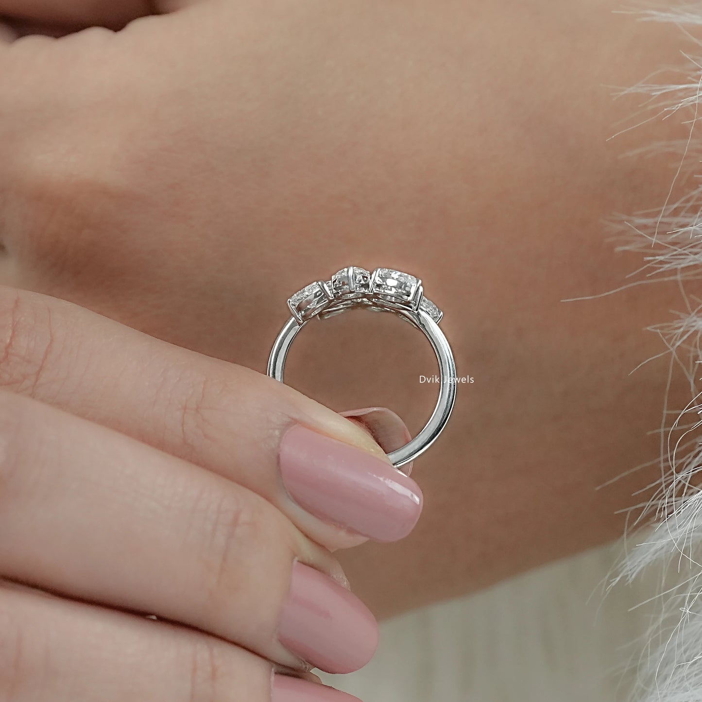 Women holding lab grown diamond bypass ring crafted with pear-cut stones