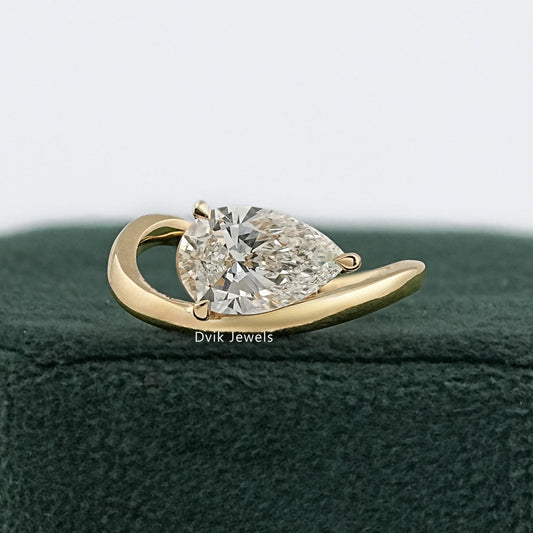 East west teardrop ring yellow gold front view on green box