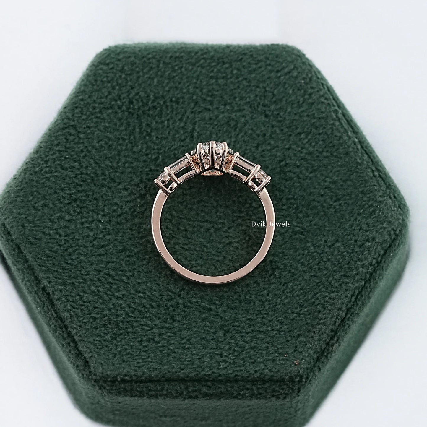 Pear diamond engagement ring with 5-stone diamond displayed on box