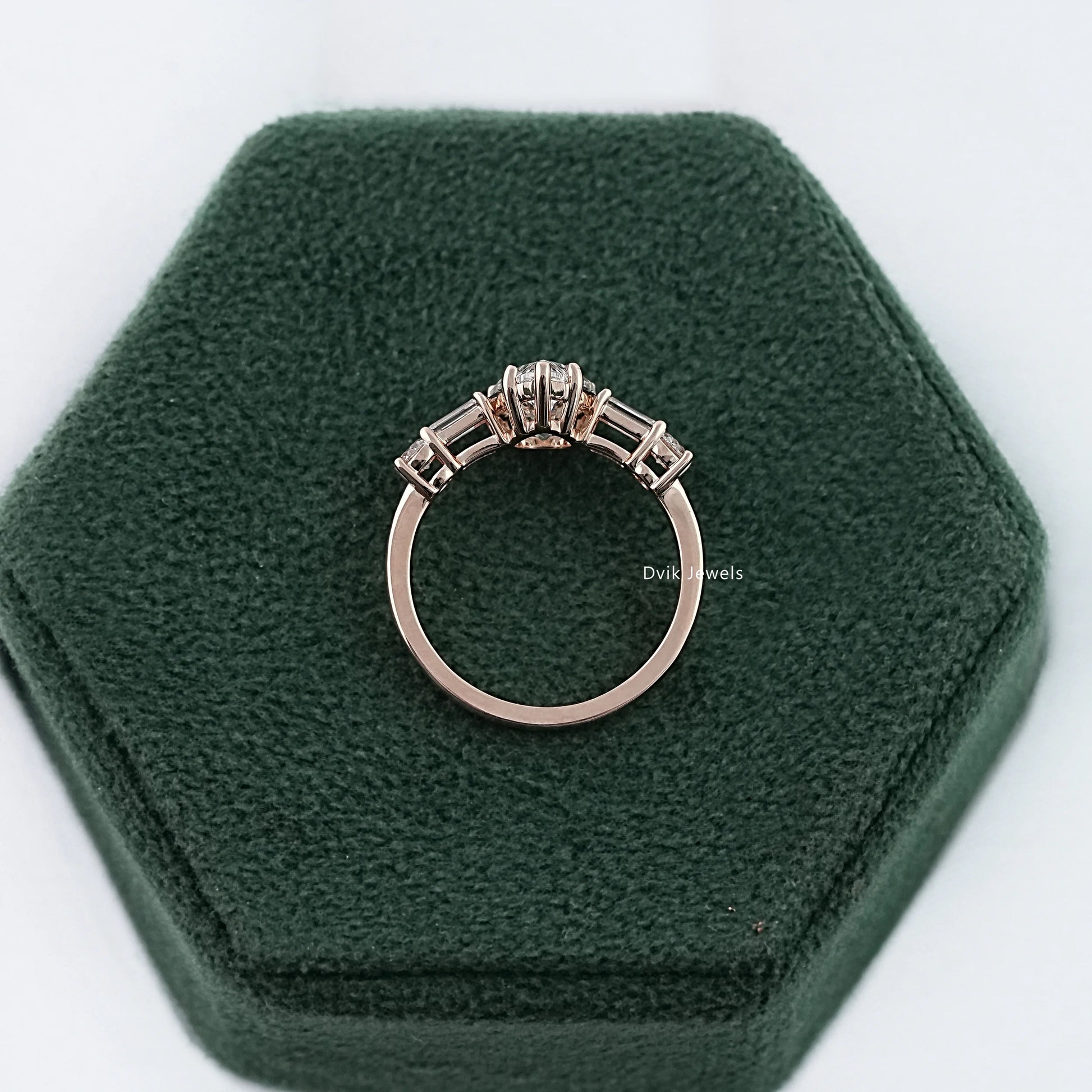 Pear diamond engagement ring with 5-stone diamond displayed on box