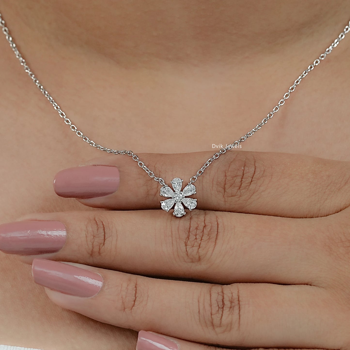 Close-up of a floral diamond cluster pendant with high-clarity facets of pear and round cut