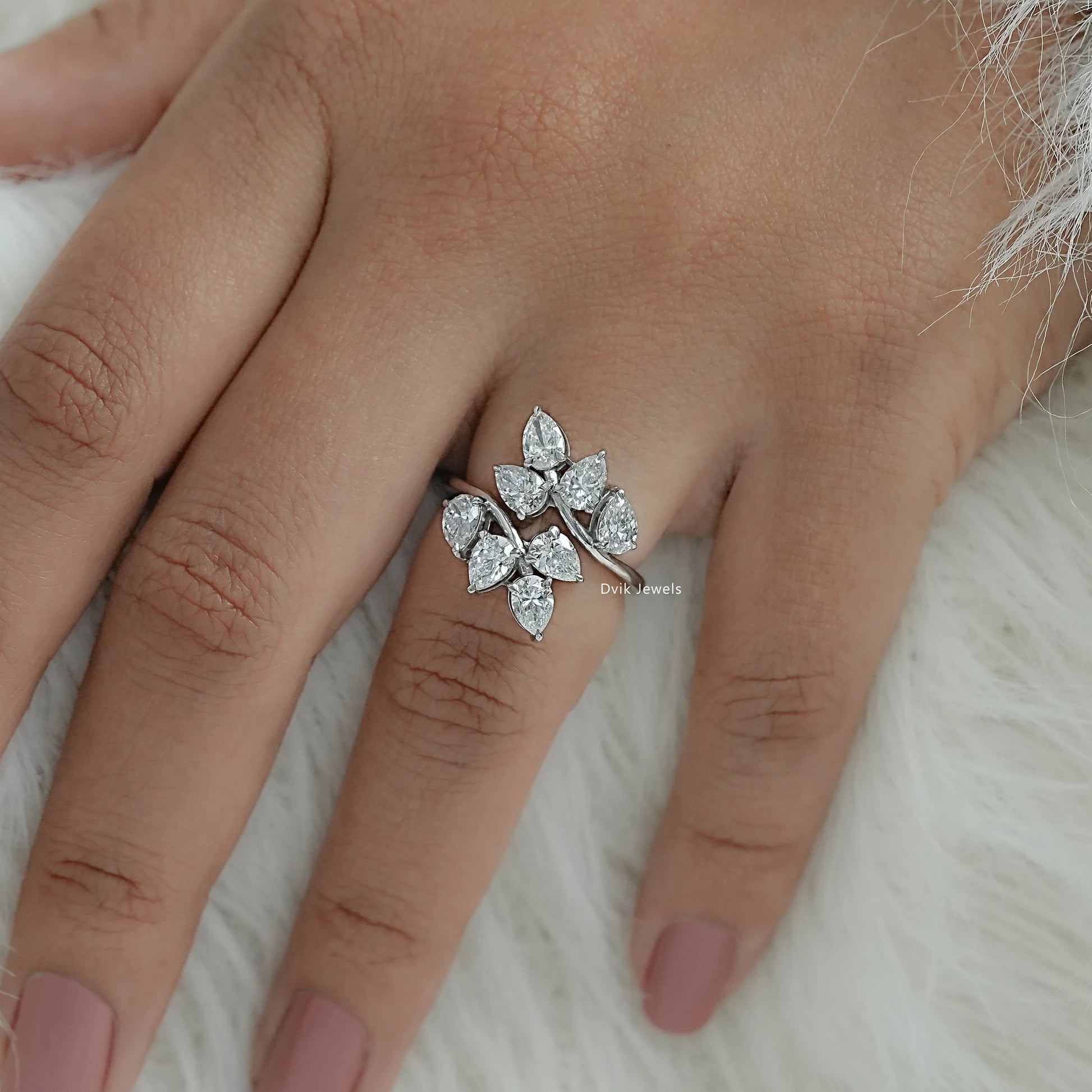 Bypass cluster ring featuring EF_VS clarity pear cut diamond worn by women for minimal look