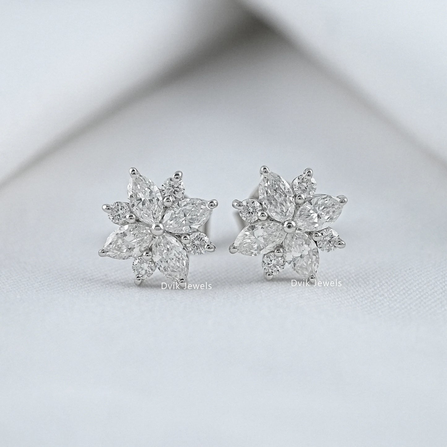 Round cut flower stud earrings with marquise stones front view