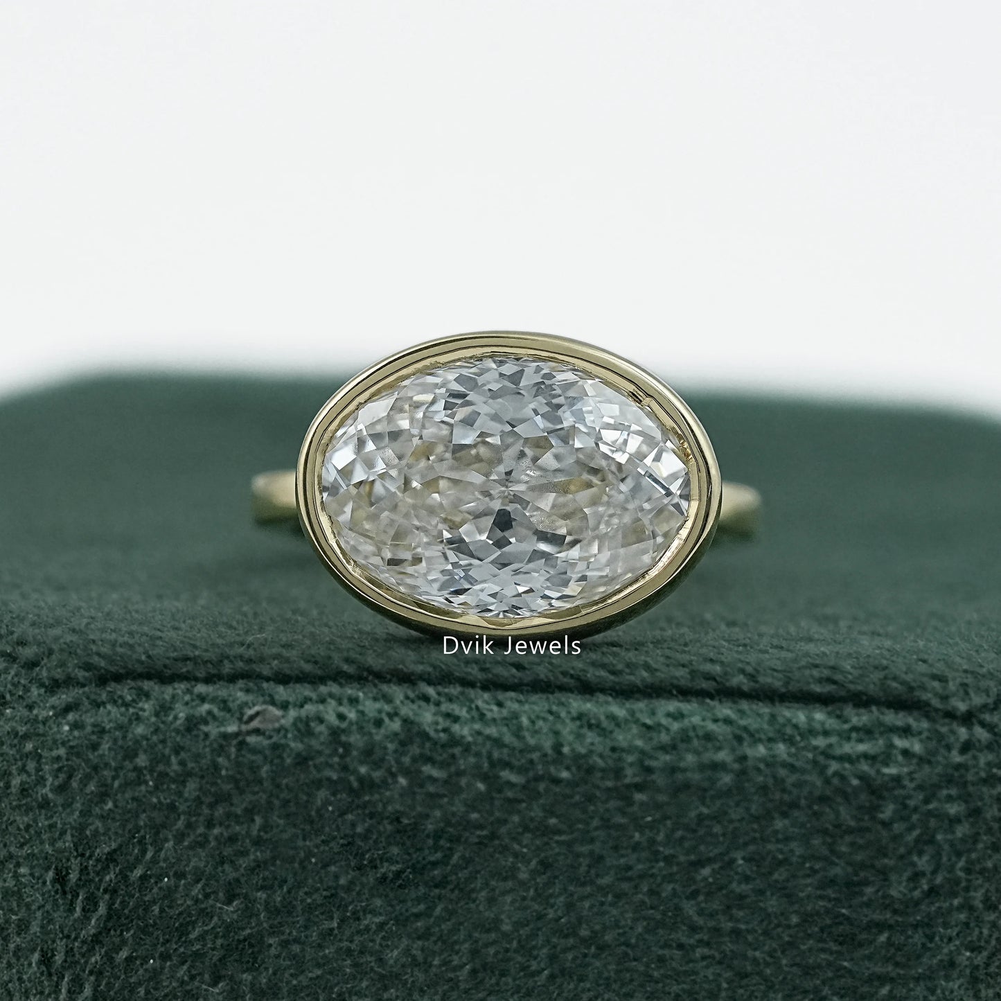 Bezel set oval engagement ring yellow gold solitaire front view