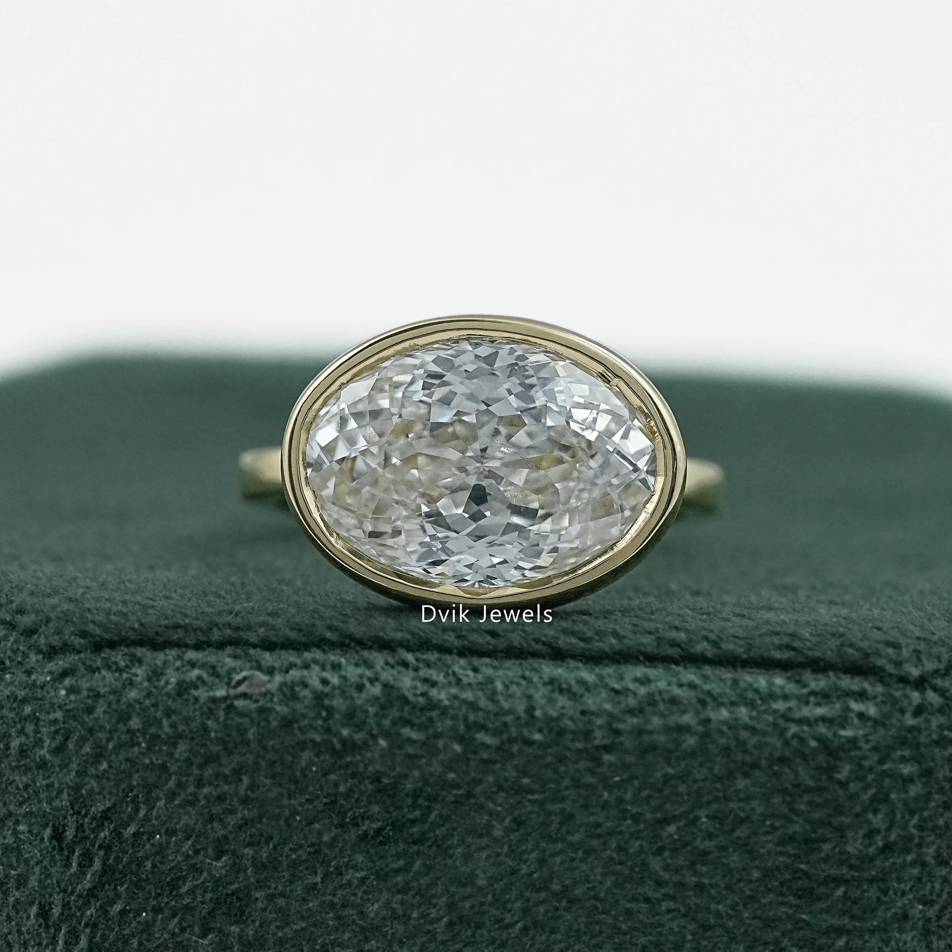 Bezel set oval engagement ring yellow gold solitaire front view