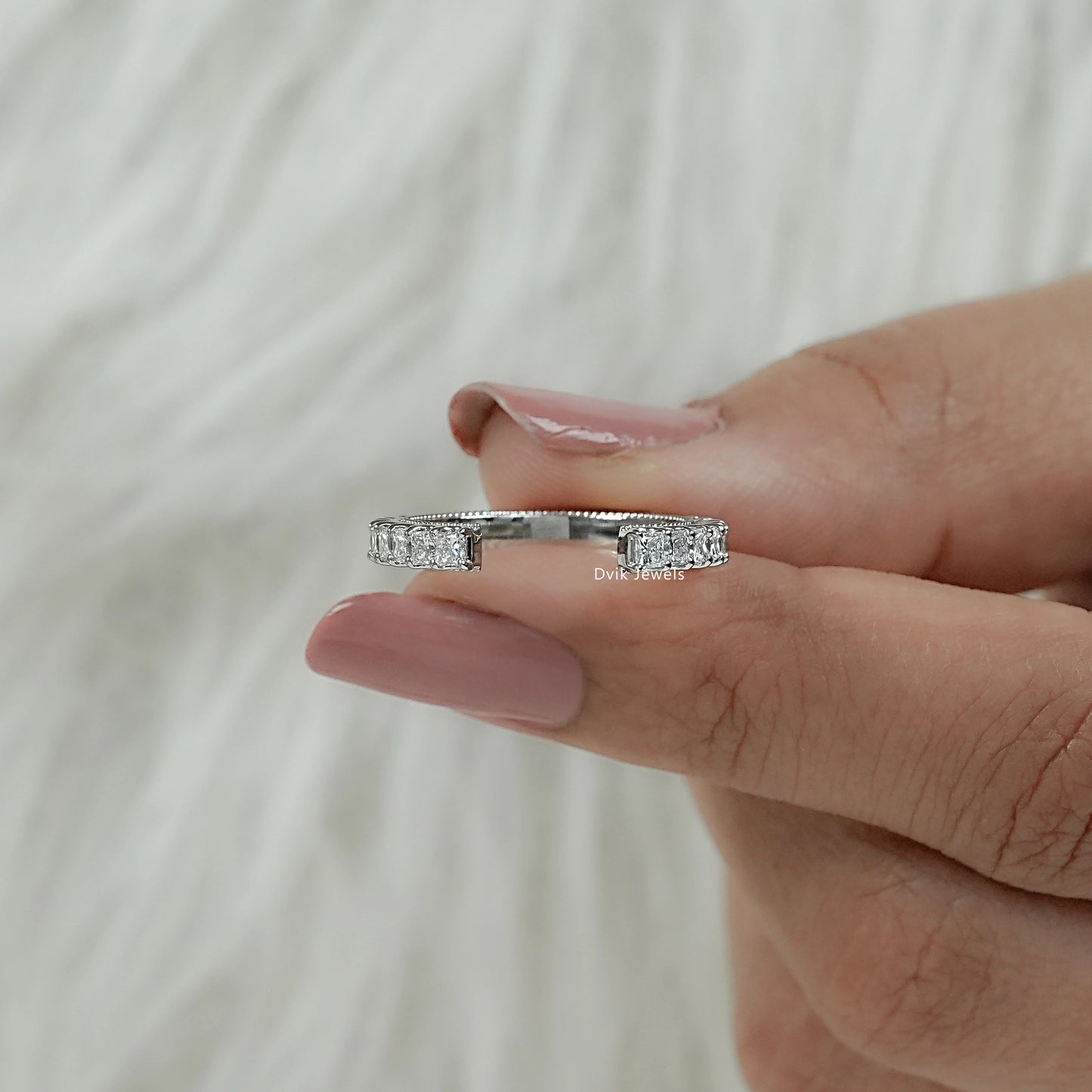 Women hold square princess cut lab diamonds with open-ended band showing bypass-inspired design