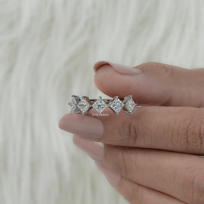 Side profile of diamond wedding bands for women held vertically for our USA bridal market.