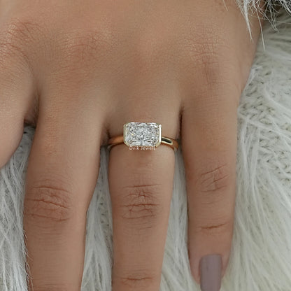 Radiant cut diamond with bezel yellow gold on finger front view