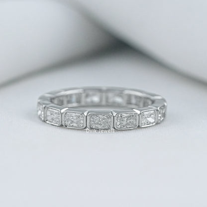 Radiant cut bezel set wedding band in 14k gold with a secure setting
