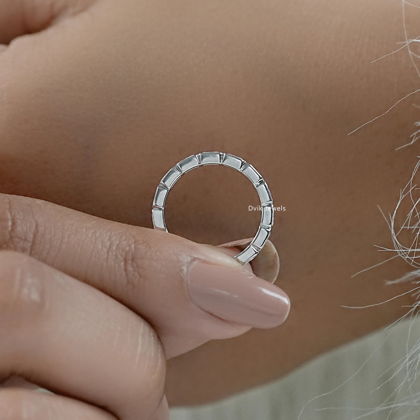 Radiant cut eternity band shown in a detailed close-up side view.