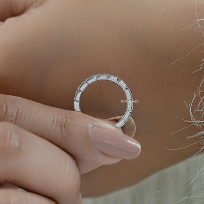 Radiant cut eternity band shown in a detailed close-up side view.