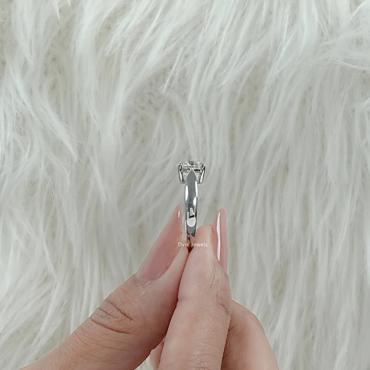 Lab Made Diamond Round Cut Solitaire Engagement Ring held by woman showing sleek band