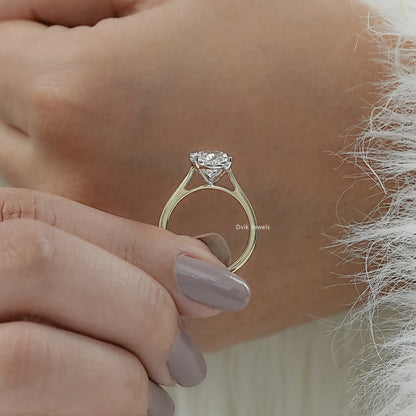 Hand hold view of a big oval engagement ring, highlighting the large surface area and facets.