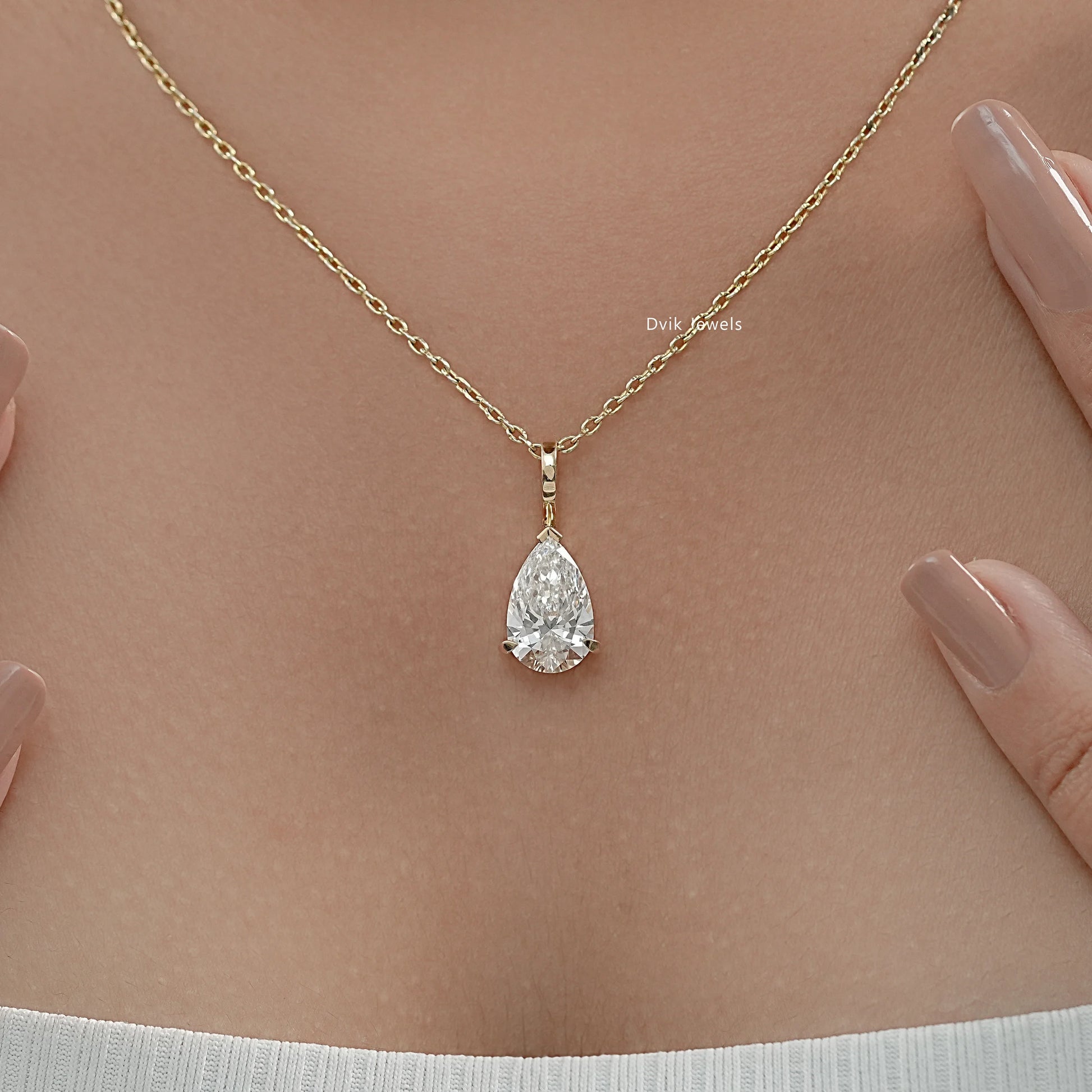 Lab grown diamond pendant with delicate yellow gold chain worn by women