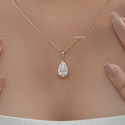 Lab grown diamond pendant with delicate yellow gold chain worn by women