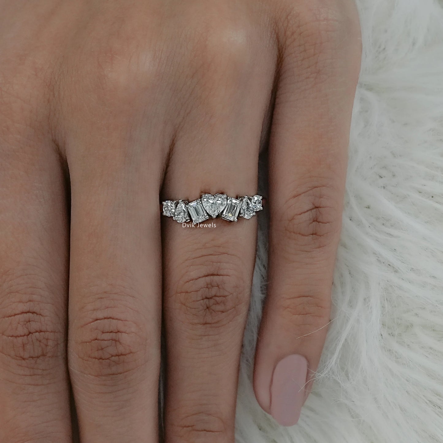 Top view of a multi shape diamond wedding band on a finger for our USA customers.