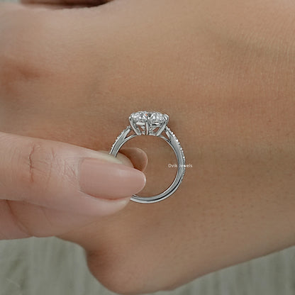 Round diamond engagement ring white gold with detailed side profile view.