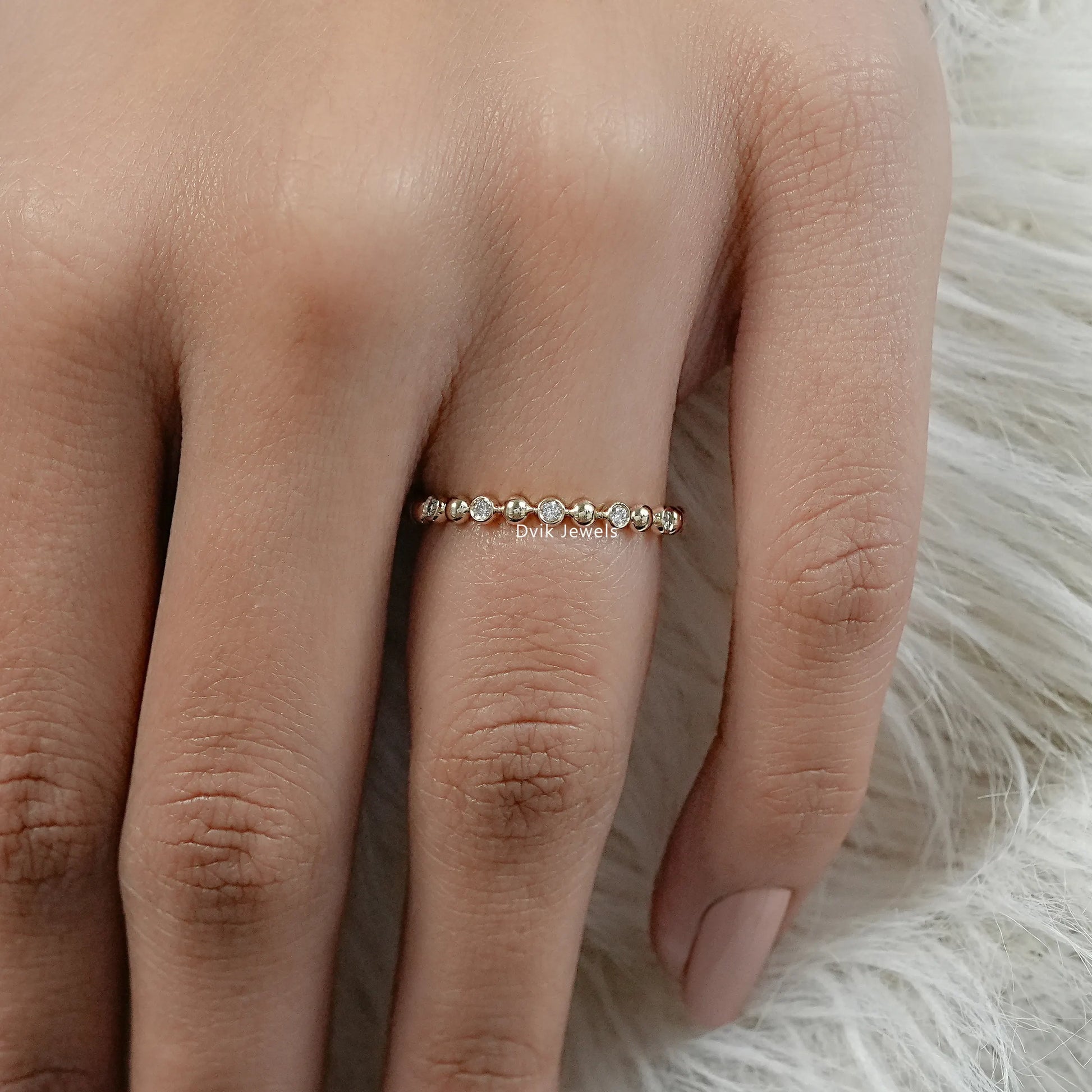 Bubble diamond wedding band yellow gold on finger front view