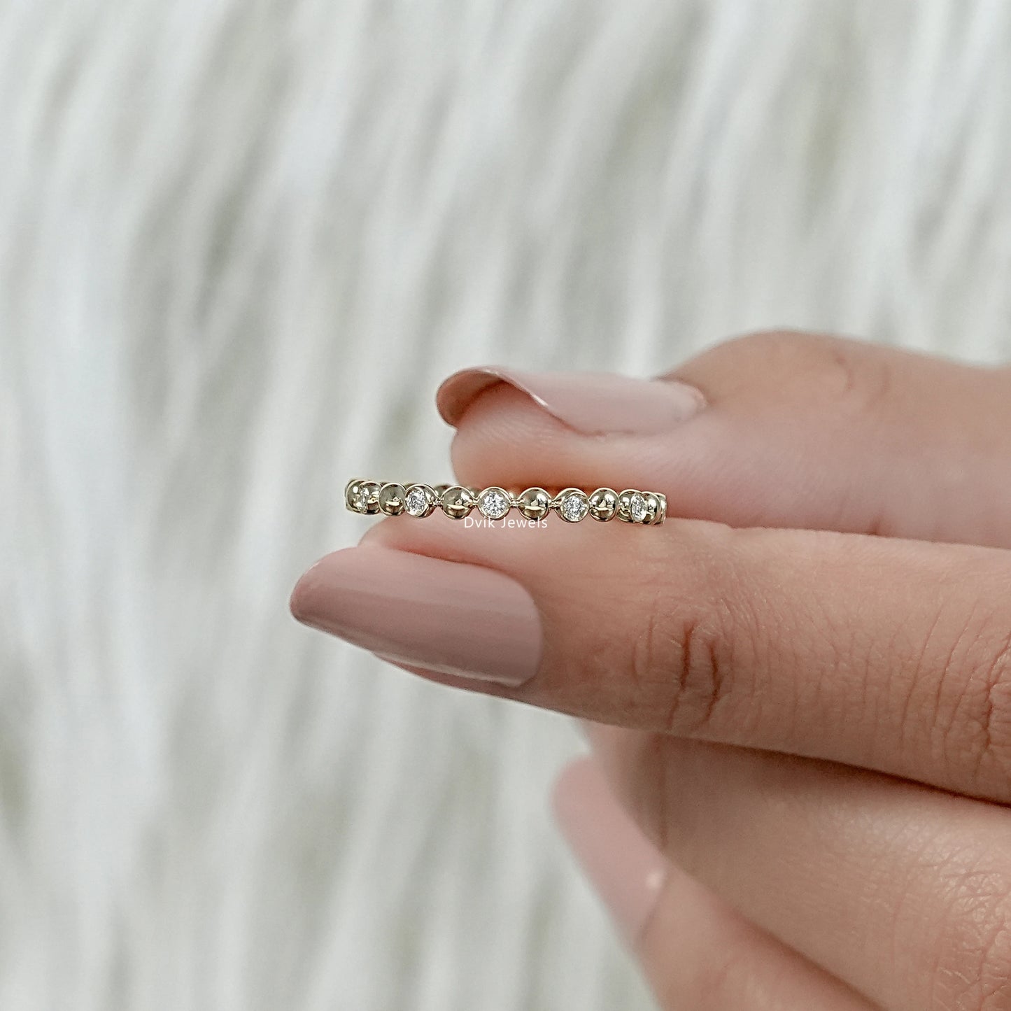 Round diamond eternity band yellow gold bubble bezel setting