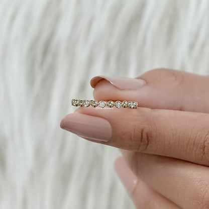Round diamond eternity band yellow gold bubble bezel setting