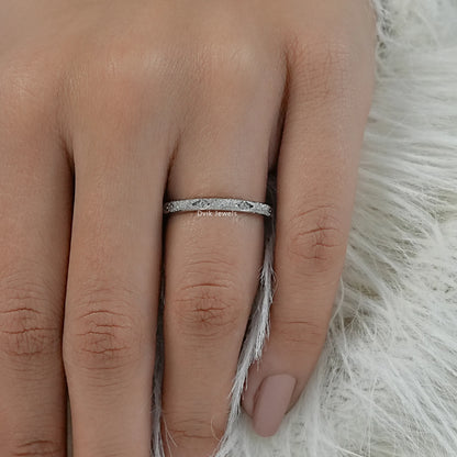 Textured wedding band women's silver on finger front view