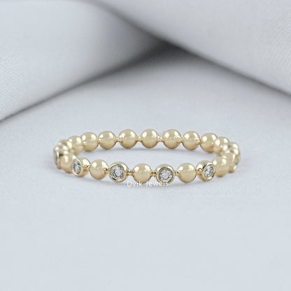 Round cut diamond wedding band yellow gold bezel bubble setting