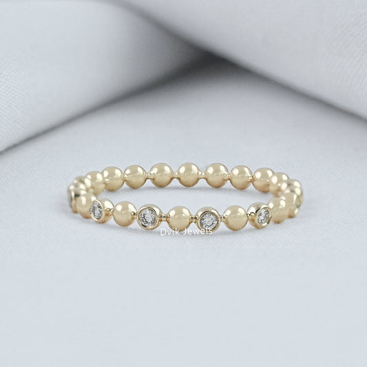 Round cut diamond wedding band yellow gold bezel bubble setting