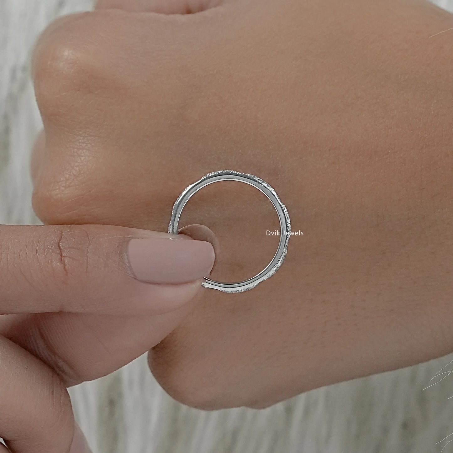 Textured gold wedding band with diamond accents side profile