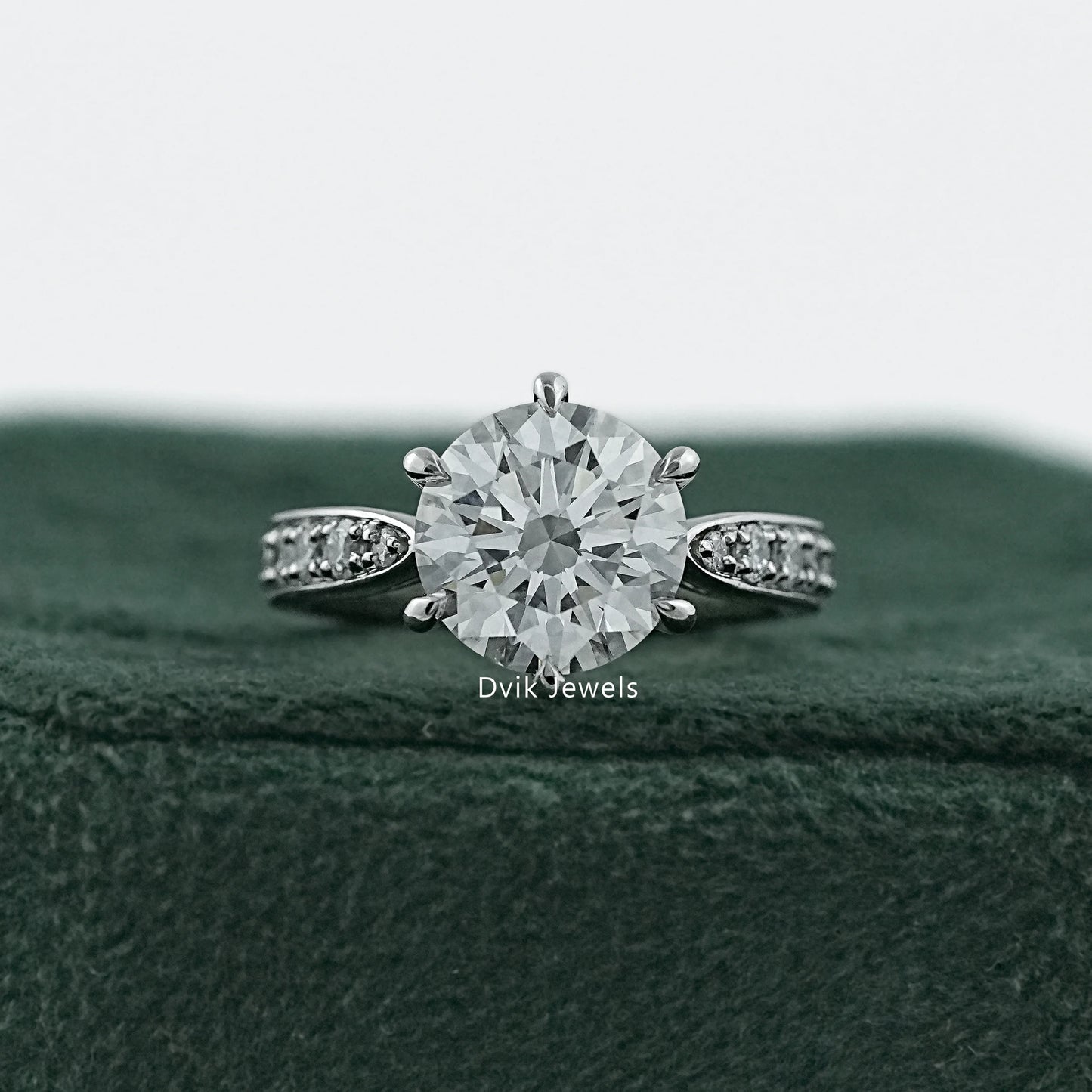 6 prong engagement ring in 14k gold with a detailed cluster halo.