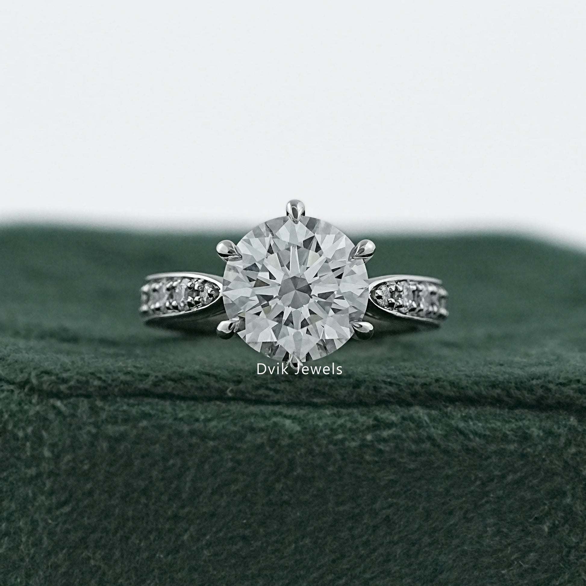 6 prong engagement ring in 14k gold with a detailed cluster halo.