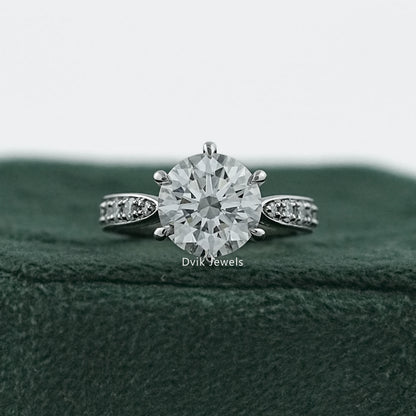 6 prong engagement ring in 14k gold with a detailed cluster halo.