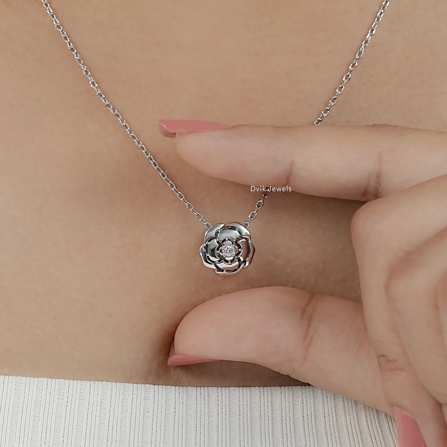 Round cut floral necklace with fine cable chain on model neck