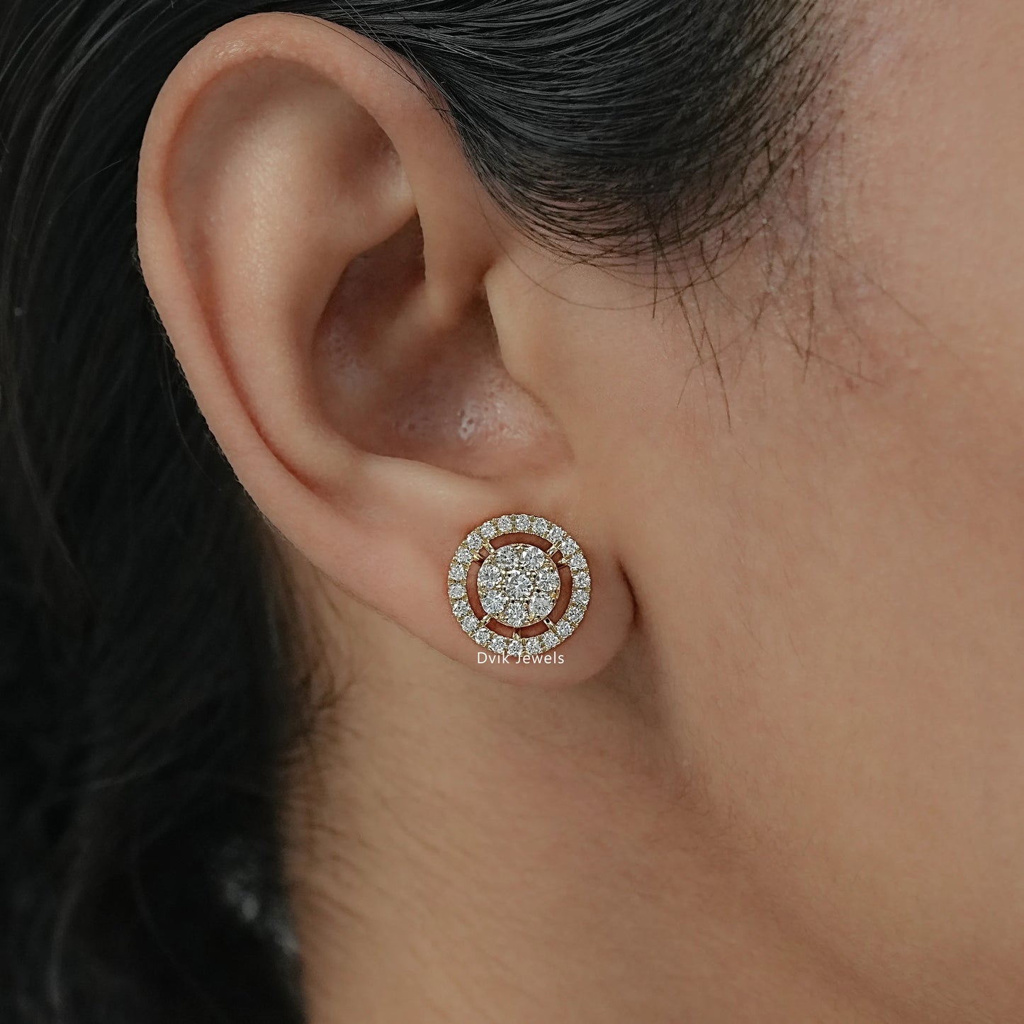 Women wear diamond earrings with round brilliant cut in solid 14k gold