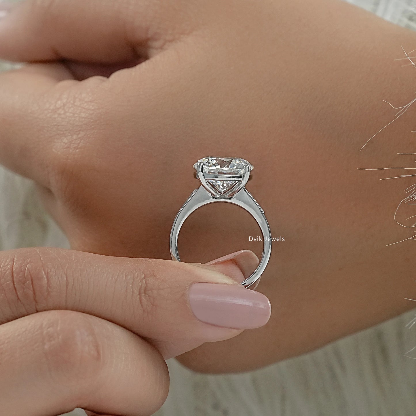 Round diamond with baguettes engagement rings baguette side stone ring profile view