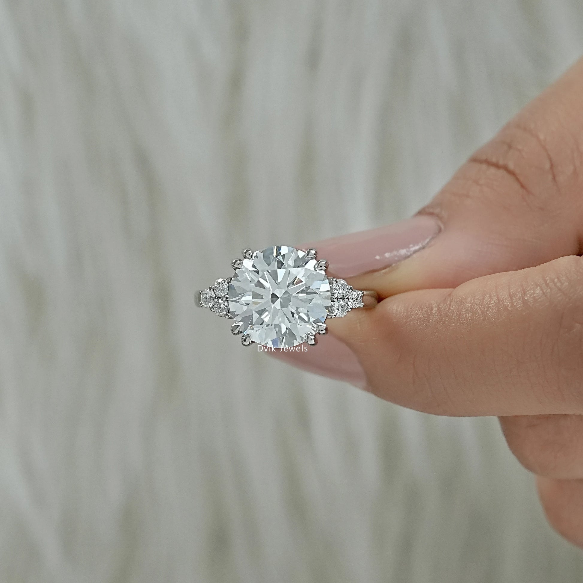 Three stone round ring with 5 carat round diamond engagement ring Finger view